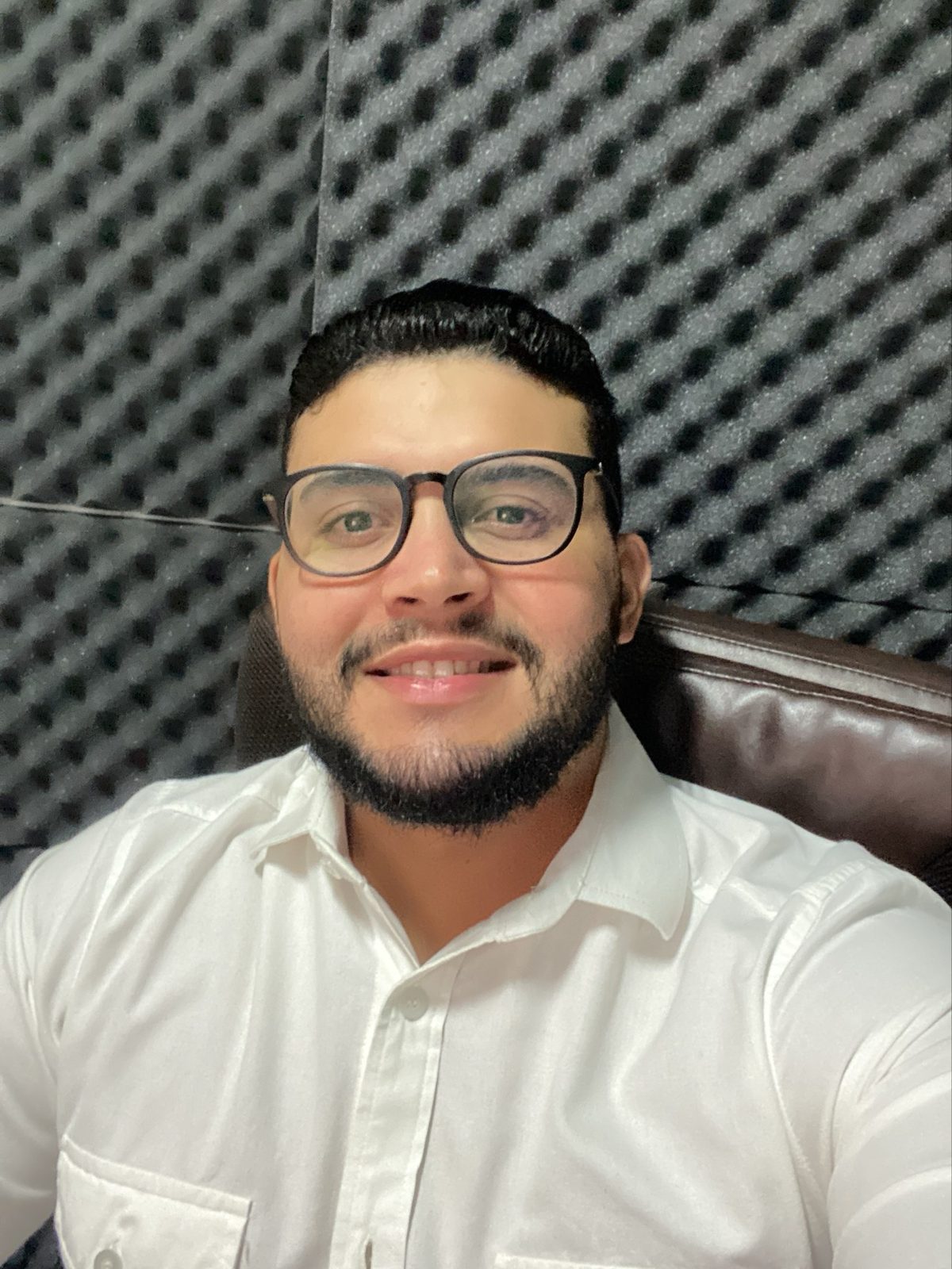 Gabriel de Freitas Carvalho in a white shirt and glasses, smiling at the camera